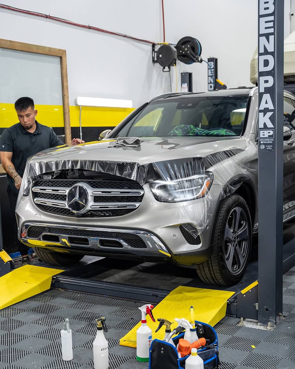 Team member applying paint protection film on a Mercedes-Benz
