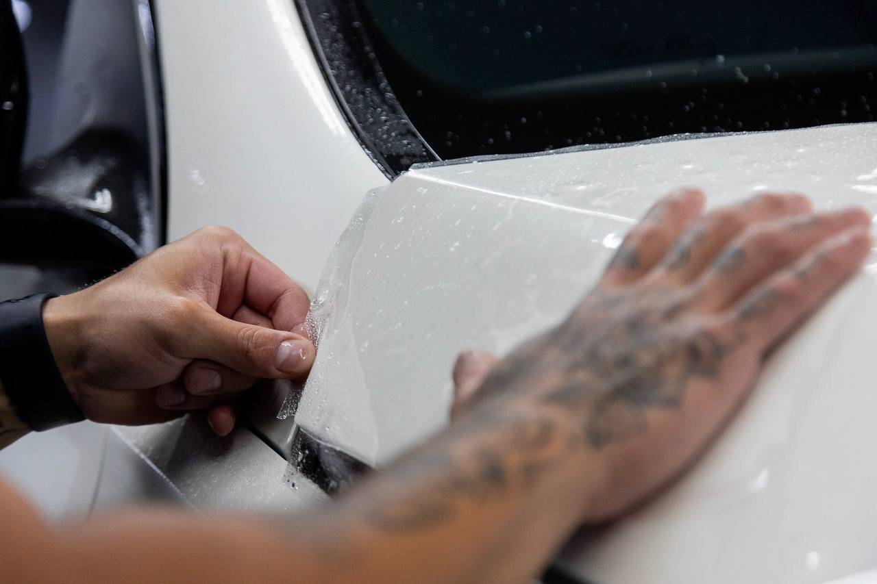 Hands applying paint protection film